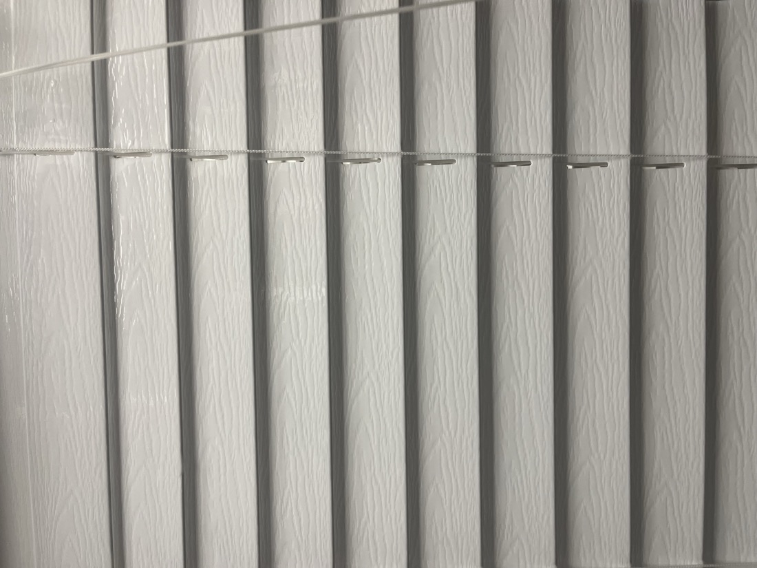 Fresh clean white vertical blinds after Capital Blind cleaning