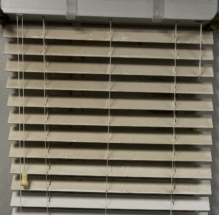 Dirty beige venetian blinds before professional cleaning in Ottawa